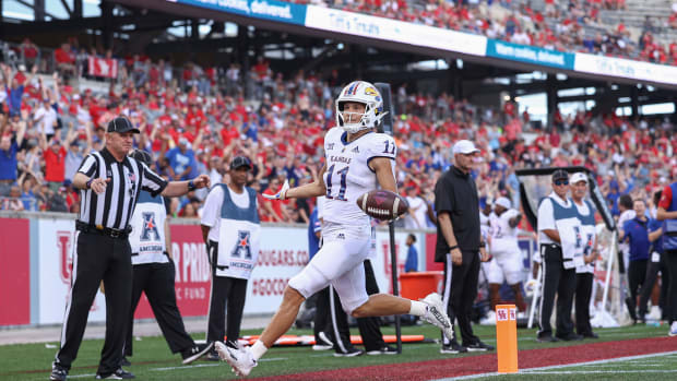 Sep 17, 2022; Houston, Texas, USA; Kansas Jayhawks wide receiver Luke Grimm (11) reacts after scoring a touchdown during the second quarter against the Houston Cougars at TDECU Stadium